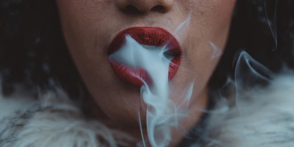 girl with smoke coming out of her mouth